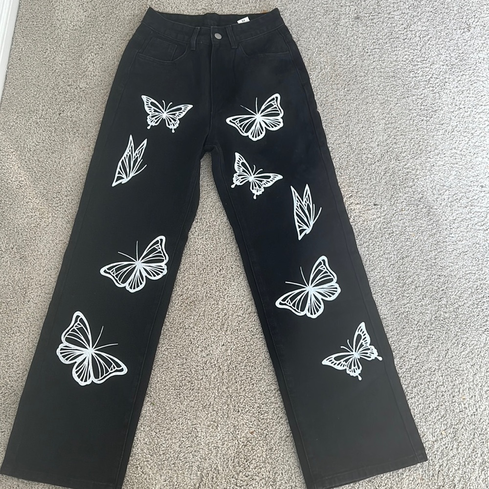 Black jeans with butter fly prints. 41 inches